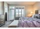 Bright bedroom with balcony access and a comfortable bed offers a tranquil retreat at 7010 W Alaska Dr, Lakewood, CO 80226