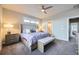 Spacious bedroom with bench seating and ensuite bath, featuring a comfortable layout at 7010 W Alaska Dr, Lakewood, CO 80226