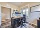 Comfortable home office featuring a spacious desk, ergonomic chair, and abundant natural light for a productive workspace at 7010 W Alaska Dr, Lakewood, CO 80226
