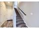 Carpeted stairway with modern handrail leading to the upper level at 7010 W Alaska Dr, Lakewood, CO 80226