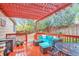 Inviting back deck with comfortable seating area beneath a stylish pergola at 18619 E Vassar Dr, Aurora, CO 80013