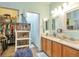 Bathroom featuring double sink vanity, shower and walk in closet at 18619 E Vassar Dr, Aurora, CO 80013
