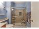 Modern bathroom featuring an accessible shower with a glass door and grab bars at 18619 E Vassar Dr, Aurora, CO 80013