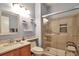 Bathroom with a glass-enclosed shower, granite countertop, and matching vanity at 18619 E Vassar Dr, Aurora, CO 80013