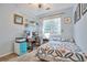 Cozy bedroom featuring a home office area, window, and a comfortable-looking bed at 18619 E Vassar Dr, Aurora, CO 80013
