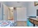 Bedroom featuring a closet with sliding doors and doorway leading to the hallway at 18619 E Vassar Dr, Aurora, CO 80013