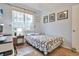 Bedroom featuring large window, desk and lamp at 18619 E Vassar Dr, Aurora, CO 80013