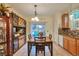 Sunlit dining area with hardwood floors, table, sliding glass doors and built in china cabinet at 18619 E Vassar Dr, Aurora, CO 80013