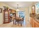Sunlit dining area with hardwood floors, table, sliding glass doors and built in china cabinet at 18619 E Vassar Dr, Aurora, CO 80013