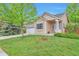 Well-manicured lawn complements this tan home with brick accents and a covered front entry at 18619 E Vassar Dr, Aurora, CO 80013