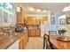 Inviting kitchen with oak cabinets, granite countertops, and eat-in dining area with natural light at 18619 E Vassar Dr, Aurora, CO 80013