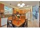 Eat in kitchen features wood cabinets, stainless steel appliances, a breakfast table and hardwood floors at 18619 E Vassar Dr, Aurora, CO 80013