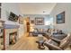 Open living room featuring a gray sectional, comfortable chairs, and natural light at 18619 E Vassar Dr, Aurora, CO 80013