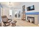 Relaxing living room with a fireplace, display cabinet, and comfortable seating arrangement at 18619 E Vassar Dr, Aurora, CO 80013