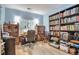 Functional office space with built-in bookcases, desk area, and ample natural light at 18619 E Vassar Dr, Aurora, CO 80013