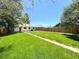 Large grassy backyard with a defined walkway leading to the house and a wooden privacy fence at 2895 Poplar St, Denver, CO 80207