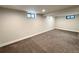 Finished basement with neutral walls, carpet, and a basement window for some natural light at 2895 Poplar St, Denver, CO 80207