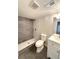 Modern bathroom featuring a tiled shower, toilet, and white vanity with sink and mirror at 2895 Poplar St, Denver, CO 80207