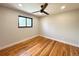 Bedroom featuring hardwood floors, fresh paint, and a fan at 2895 Poplar St, Denver, CO 80207