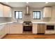 Bright kitchen featuring stainless steel appliances, white cabinets, and quartz countertops at 2895 Poplar St, Denver, CO 80207
