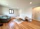 Cozy living room with hardwood floors, large window, and comfortable seating at 2895 Poplar St, Denver, CO 80207
