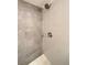Modern bathroom featuring a tiled shower with updated shower head and fixtures at 2895 Poplar St, Denver, CO 80207