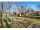 Spacious backyard featuring a fire pit and chairs, ideal for outdoor entertaining on a sunny day at 6755 W 33Rd Ave, Wheat Ridge, CO 80033