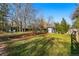 Well-maintained backyard with lush green grass, mature trees, and a storage shed for convenience at 6755 W 33Rd Ave, Wheat Ridge, CO 80033