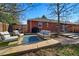 Backyard patio area featuring an outdoor seating set, blue rug, wooden fence, and an outdoor grill at 6755 W 33Rd Ave, Wheat Ridge, CO 80033