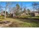 Large backyard featuring a fire pit, garden beds, storage shed, and a wood fence at 6755 W 33Rd Ave, Wheat Ridge, CO 80033