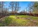 Spacious backyard featuring a wooden fence, edging around the lawn and mature trees at 6755 W 33Rd Ave, Wheat Ridge, CO 80033