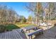 Large backyard featuring a wooden patio set, an outdoor grill, a wooden fence, and a well maintained lawn at 6755 W 33Rd Ave, Wheat Ridge, CO 80033