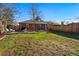 Spacious backyard features a brick home, wooden fence, manicured lawn, and patio with an outdoor grill at 6755 W 33Rd Ave, Wheat Ridge, CO 80033