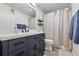 Bathroom featuring a navy blue vanity, white countertops, and shower with curtain at 6755 W 33Rd Ave, Wheat Ridge, CO 80033