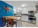 Bright kitchen with white cabinetry, stainless steel appliances, and a breakfast bar at 6755 W 33Rd Ave, Wheat Ridge, CO 80033