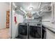 Well-organized laundry room with modern washer and dryer, practical shelving, and storage solutions at 6755 W 33Rd Ave, Wheat Ridge, CO 80033