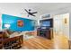 Cozy living area with hardwood floors, ceiling fan, and entertainment center at 6755 W 33Rd Ave, Wheat Ridge, CO 80033