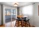 Dining area with a round table, four chairs, and sliding glass doors to a patio at 2169 E 116Th Ave, Northglenn, CO 80233