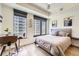 Bright bedroom with expansive windows offering stunning city views and a light airy decor at 1750 Wewatta St # 805, Denver, CO 80202