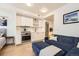 This stylish living room with stainless appliances is adjoined by a cozy space with a blue couch and a large ottoman at 1750 Wewatta St # 805, Denver, CO 80202
