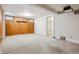 A spacious basement boasting carpeted floors, paneled walls, and ample natural light from windows at 869 S Williams St, Denver, CO 80209