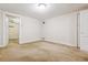 A bright bedroom featuring carpeted floors, white walls, closet, and a hallway entrance at 869 S Williams St, Denver, CO 80209