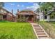 Charming brick home features a well-manicured lawn, landscaped front yard, and inviting front porch at 869 S Williams St, Denver, CO 80209