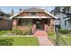 Charming brick home with a cozy front porch and landscaped front yard at 869 S Williams St, Denver, CO 80209