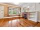Living room boasts hardwood floors, a brick fireplace with bookshelves and large windows for natural light at 869 S Williams St, Denver, CO 80209