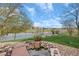 Landscaped backyard with pond and view of the water, the golf course, and neighborhood at 6802 Poppy Ct, Arvada, CO 80007