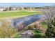 Scenic backyard view overlooking the lake, golf course, and fire pit area at 6802 Poppy Ct, Arvada, CO 80007