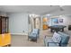 Open basement area with wet bar and a recreation area featuring comfortable seating at 6802 Poppy Ct, Arvada, CO 80007