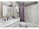 Clean bathroom with shower-tub combo, white vanity, and neutral walls at 6802 Poppy Ct, Arvada, CO 80007