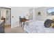 Cozy bedroom features neutral gray walls, plush carpet, and a window with lovely natural light at 6802 Poppy Ct, Arvada, CO 80007